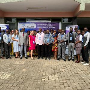 Group photo of ANSWER partners in front of ANSWER banner